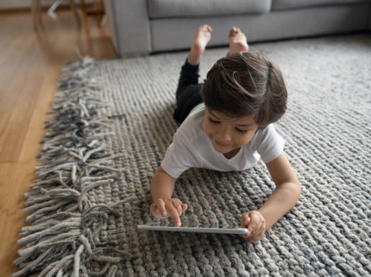 Child playing on the area rug